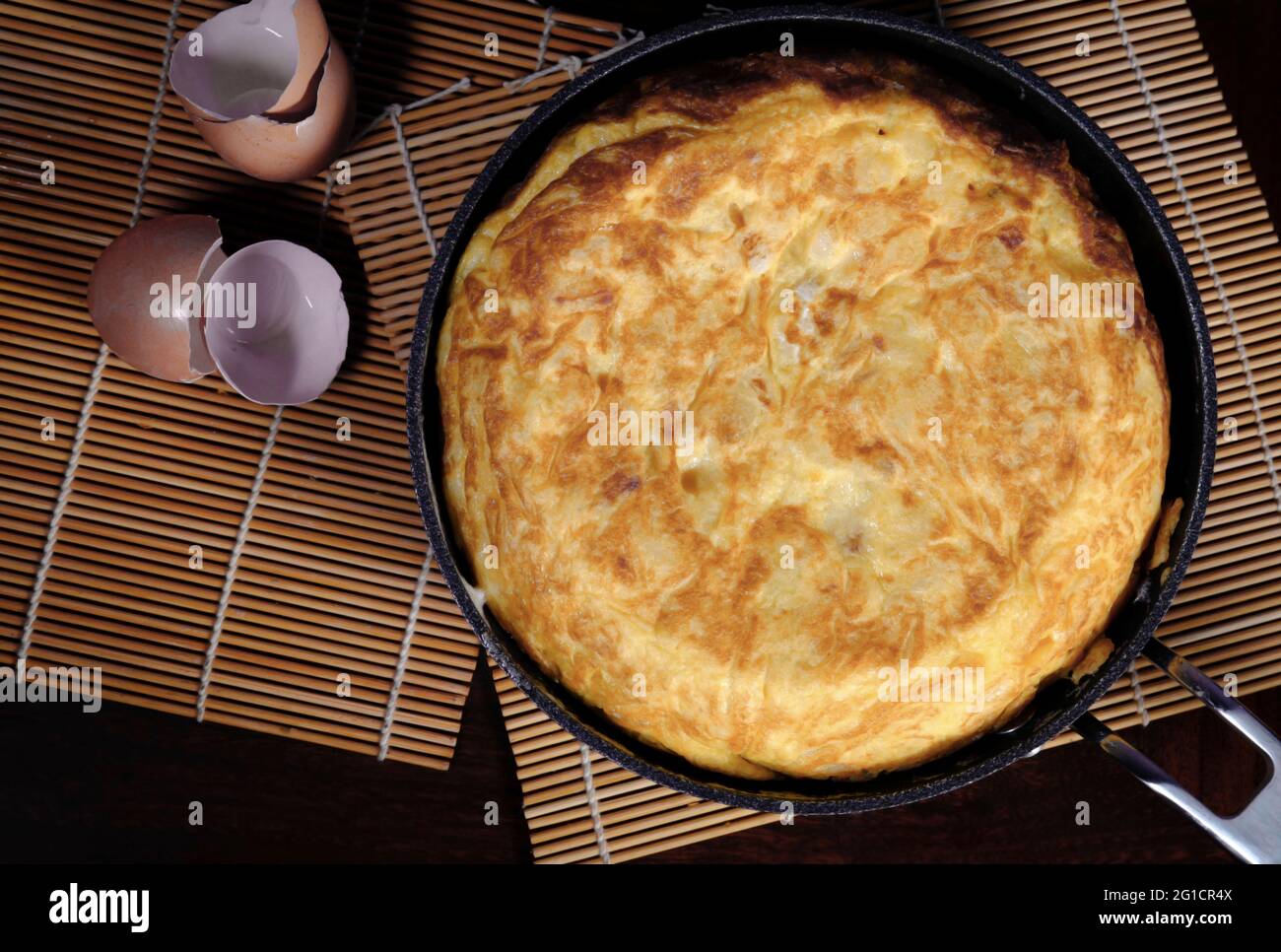 Spanish omelette with potatoes in pan on wood table Stock Photo Alamy