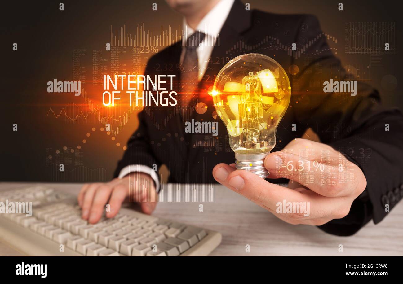 Businessman holding a lightbulb concept Stock Photo - Alamy