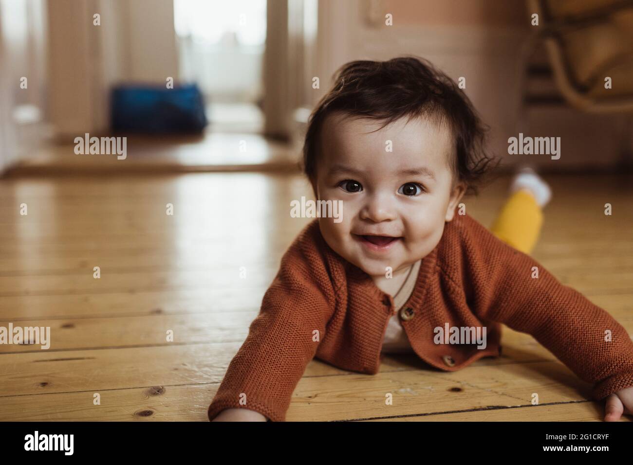 Portrait of smiling male toddler lying on floor at home Stock Photo Alamy