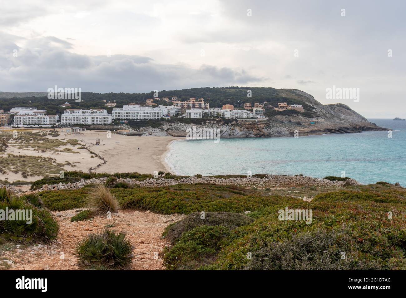 Cala Mesquida beach in Mallorca, Spain. Wild beach with dunes and hotels on a stormy day Stock Photo