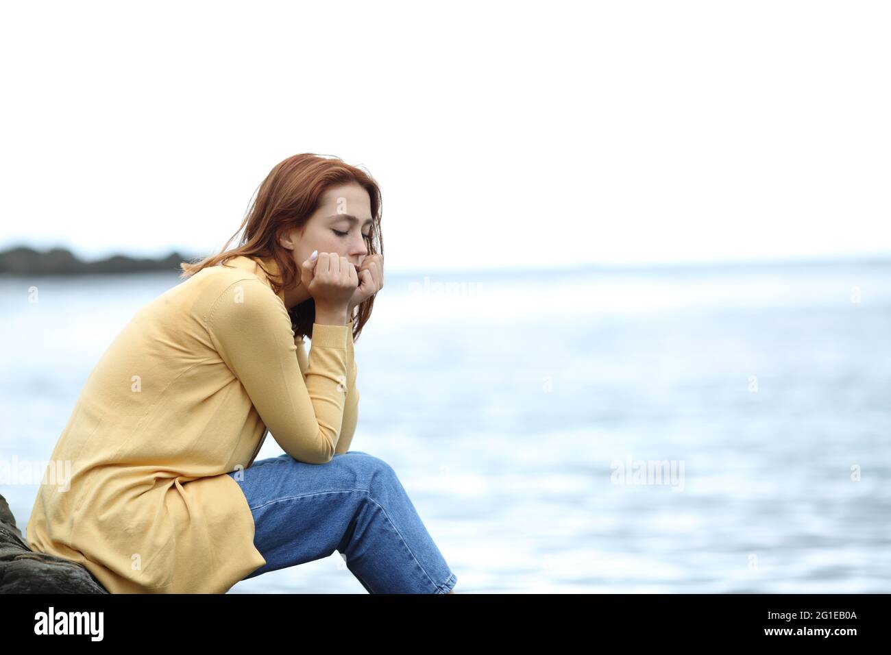 Unhappy Girl Feeling Sad On The Beach Stock Photo, Picture and