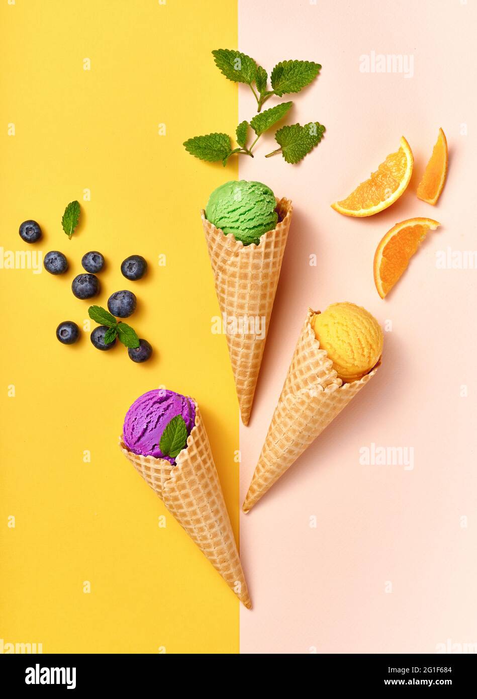 Assorted of ice cream in cones on white background. Colorful set of ice cream of different flavours. Ice cream isolated with nuts, fruits and berries. Stock Photo