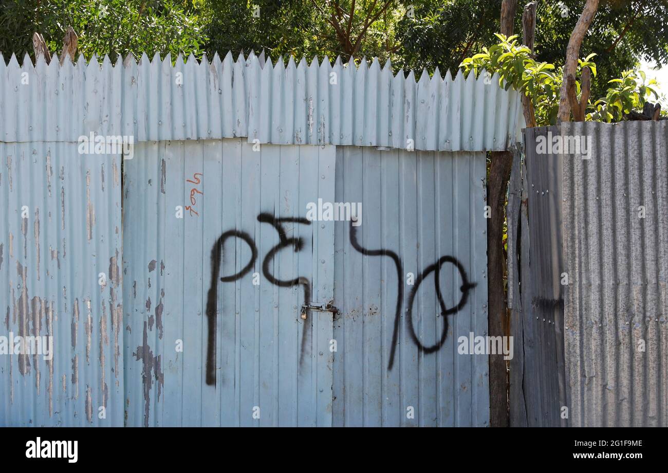 Graffiti on a gate says 'this is ours' in Amharic in the town of Mai Kadra, Ethiopia, March 6, 2021. Picture taken March 6, 2021. To match Special Report ETHIOPIA-CONFLICT/EXPULSIONS   REUTERS/Baz Ratner Stock Photo