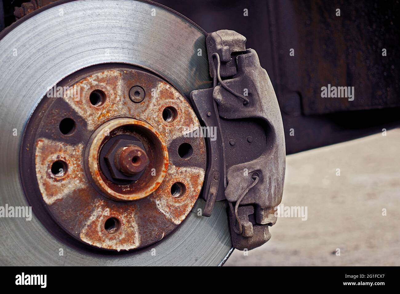 closeup of used car disc brake with caliper, color graded, focus on caliper Stock Photo