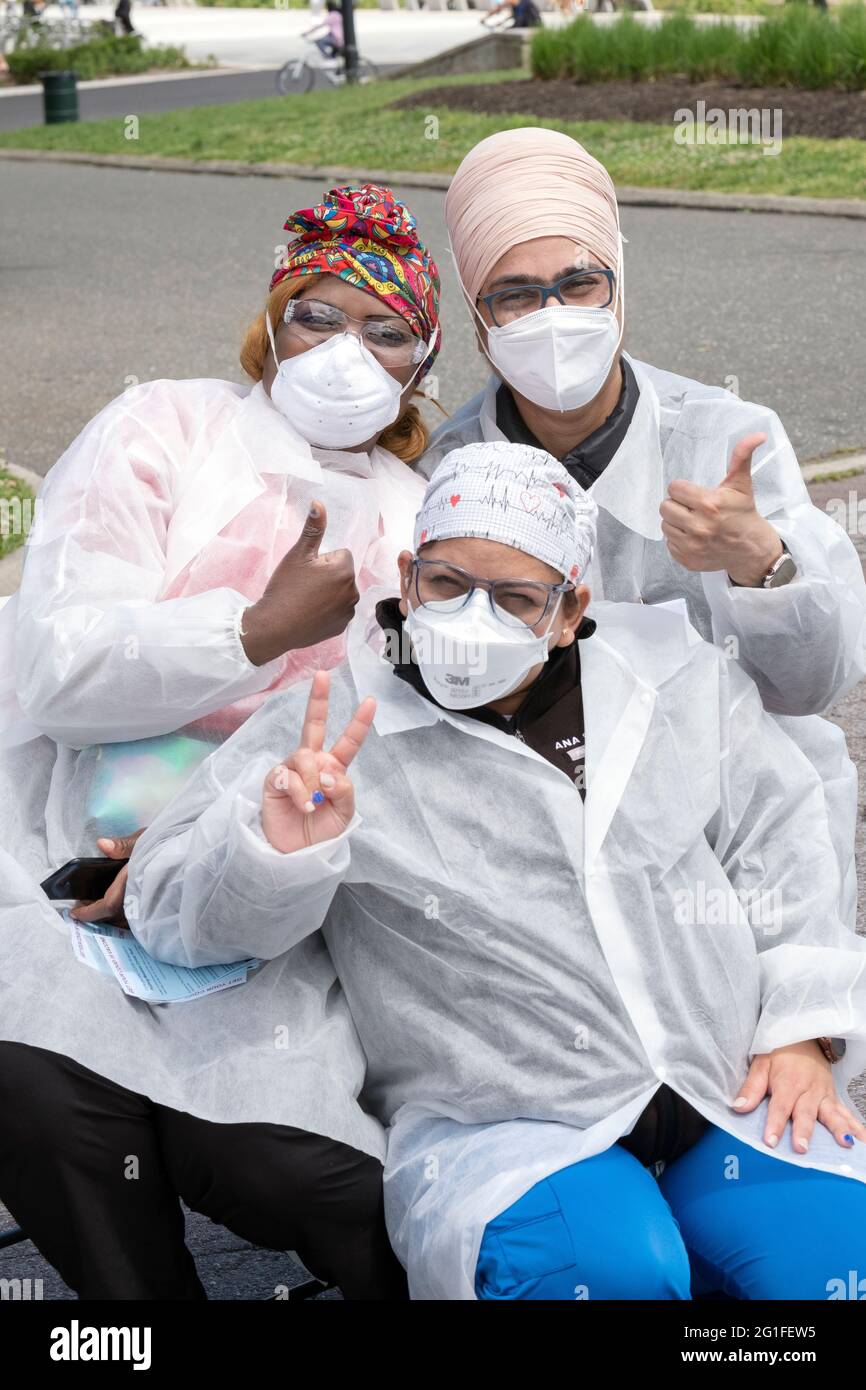 DIVERSITY. A Jamaican, Indian & South American nurse pose for a photo at a Covid vaccination site in Flushing Meadows Corona Park in Queens, New York . Stock Photo
