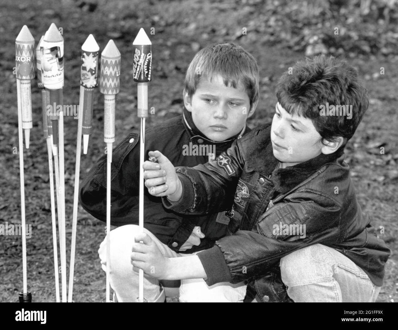 festivities, New Year's Eve, two children are igniting firework rockets ...