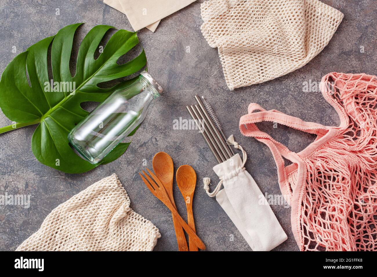 zero waste eco friendly concept. reusable cotton bag, stainless steel drinking staw, glass jar, wooden cutlery Stock Photo