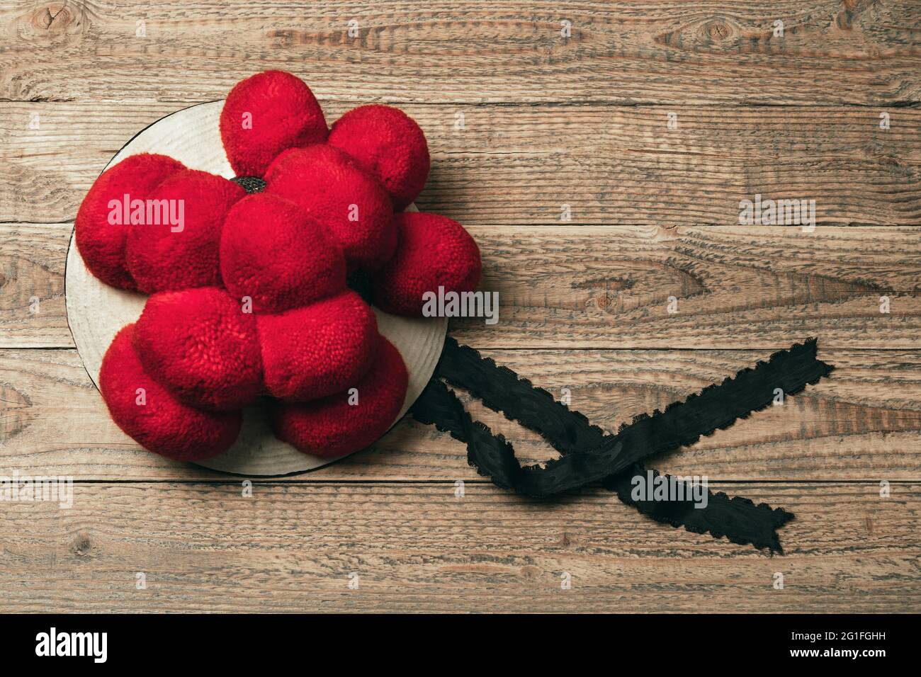 Original Black Forest Bollen hat on rustic wooden background, Germany Stock Photo