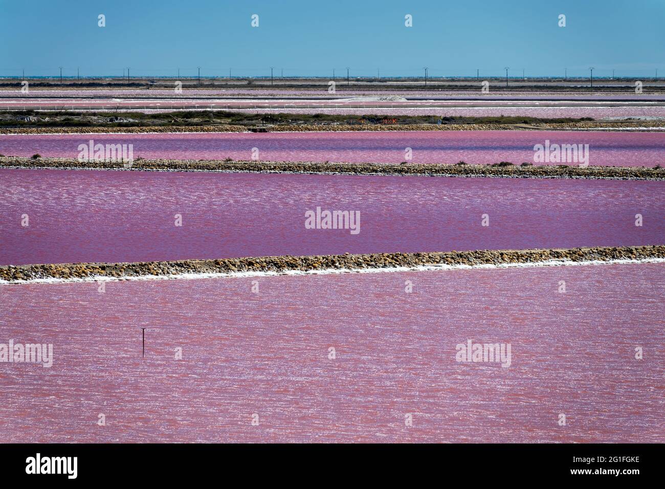 Abstract landscape of pink salt pans at Salin de Giraud saltworks in the Camargue in Provence, South of France Stock Photo