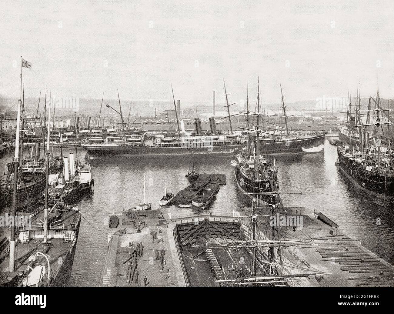 A late 19th century view of the busy docks in the Port of Southampton, a passenger and cargo port in the central part of the south coast of England. From the Middle Ages to the end of the 20th century, it was a centre for naval shipbuilding and a departure point for soldiers going to war. The opening of the railway to London in 1840 gave a boost to the port and ships  arrived in numbers that overwhelmed the town's quays and wharves, and the first dock was inaugurated in 1843 and several more until 1890 when Queen Victoria opened the Empress Dock, larger and deeper than earlier ones. Stock Photo
