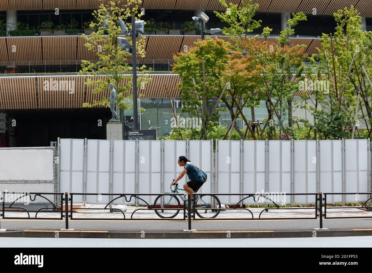 Tokyo, Japan. 7th June, 2021. A man on bicycle rides past the National