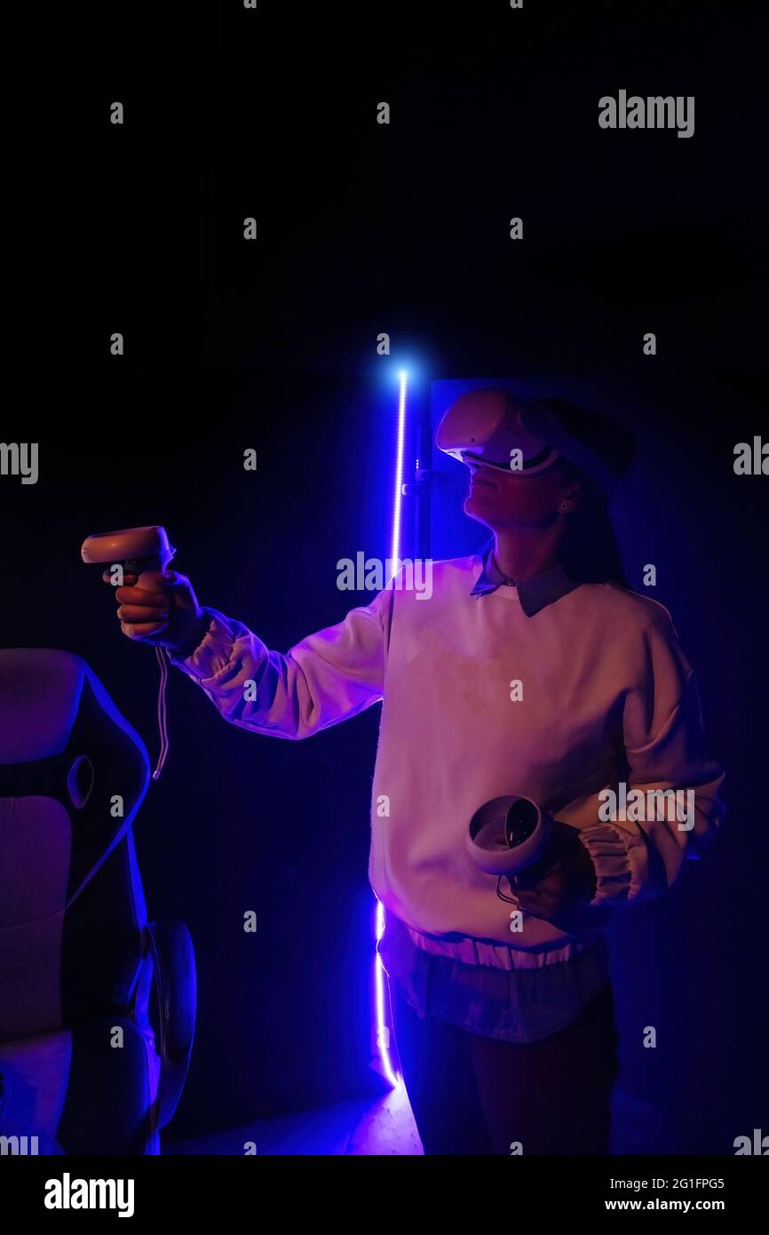 Girl in virtual reality headset with joysticks Stock Photo Alamy