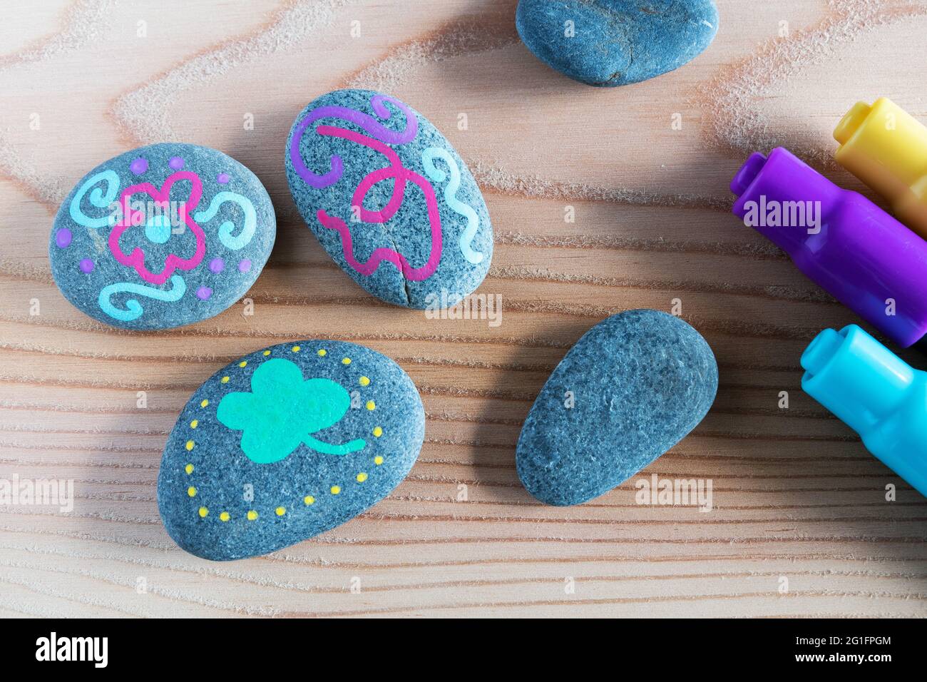 Stones painted with markers Stock Photo - Alamy