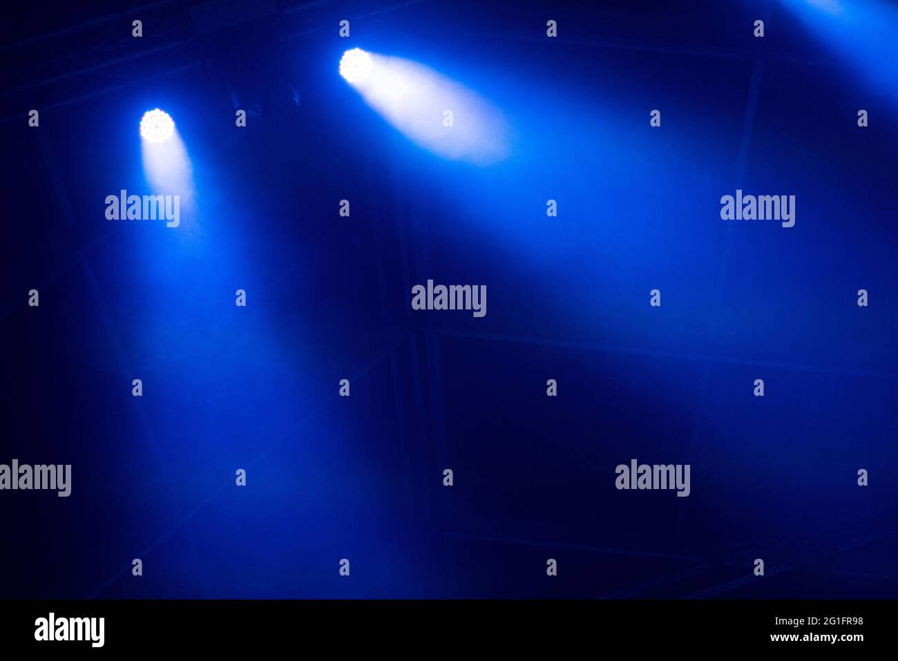 Blue stage lights glowing in the dark. Live music festival concept background Stock Photo