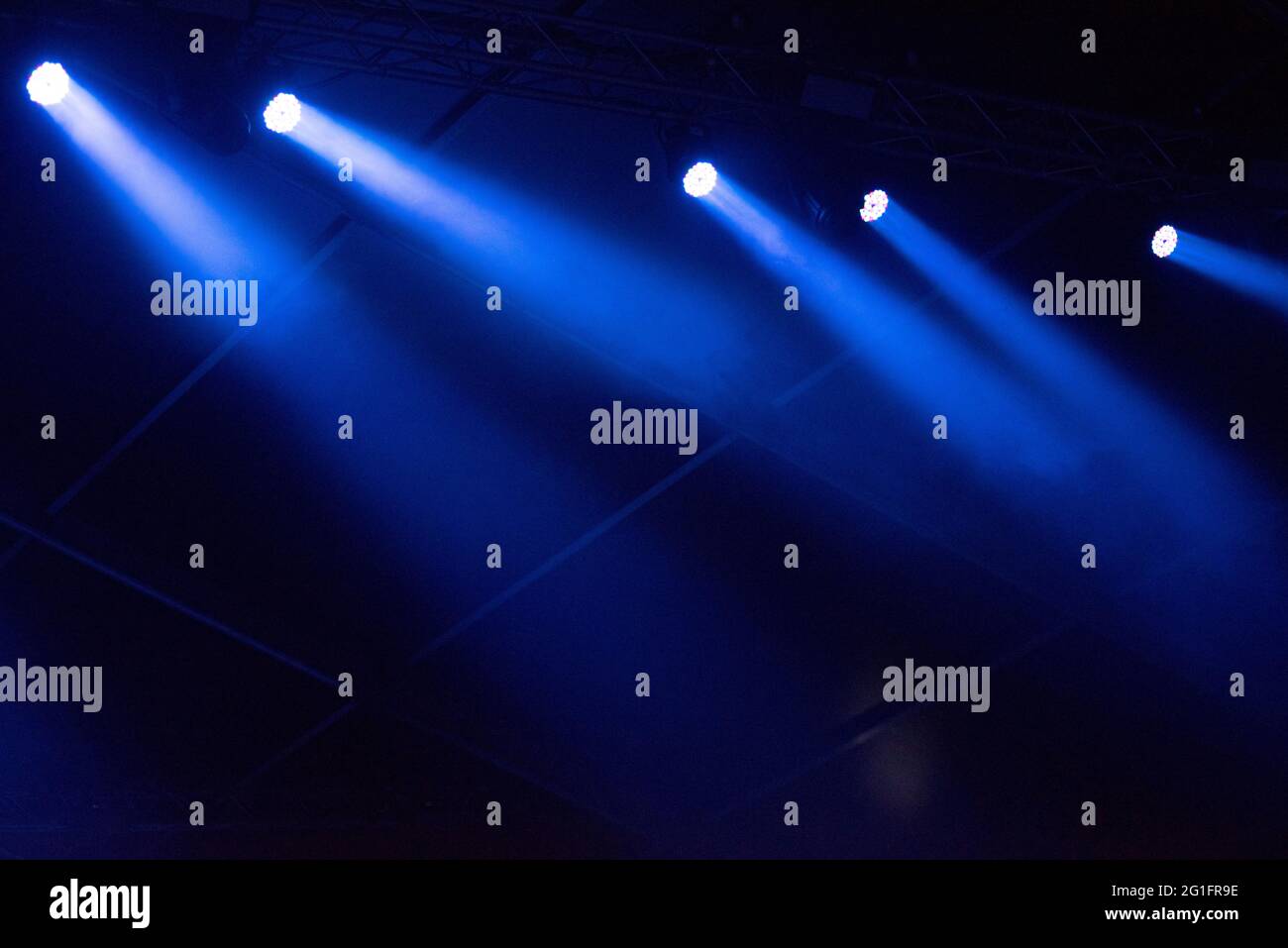 Blue stage lights glowing in the dark. Live music festival concept background Stock Photo
