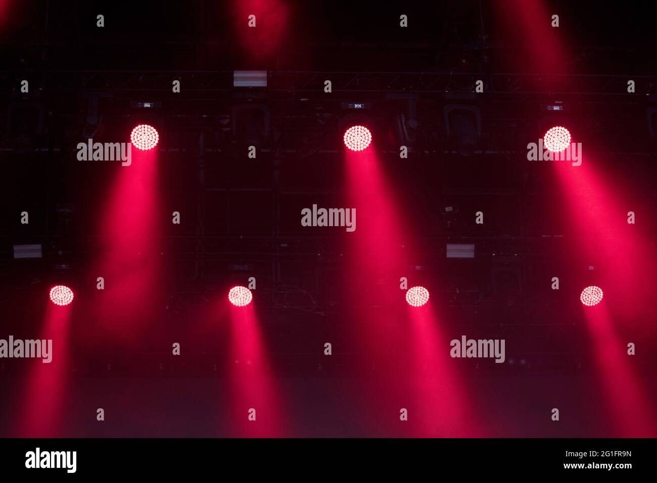 Red stage lights glowing in the dark. Live music festival concept background Stock Photo