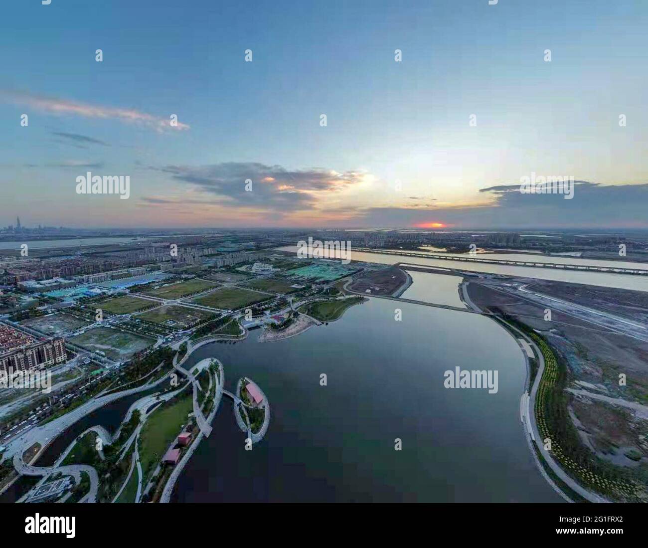 (210607) -- TIANJIN, June 7, 2021 (Xinhua) -- Aerial photo taken on June 5, 2021 shows a seaside park in the Binhai New Area of north China's Tianjin. Tianjin in north China boasts rich biodiversity along a 153-km coastline made up of muddy tidal flats. Over the years, the city has worked on pollution control and shoreline management of the Bohai Sea to restore its coastal wetlands, while stricter measures on land reclamation have been implemented. In 2020, 70.4 percent of Tianjin's offshore waters achieved sound quality under a three-year action plan to battle water pollution. Now the Stock Photo