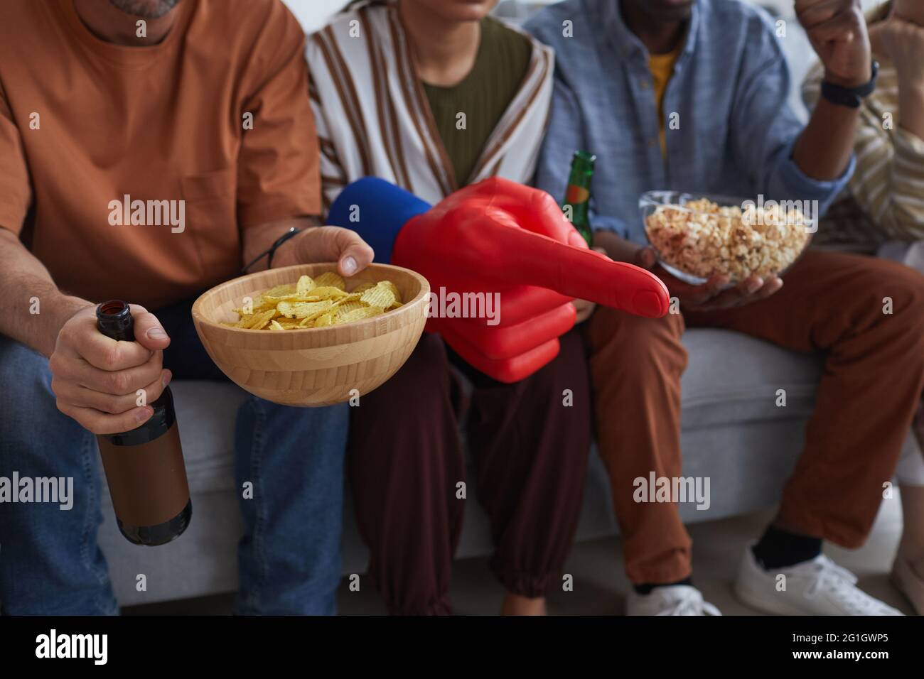 Close up of sports fans holding snacks while watching game match together, copy space Stock Photo