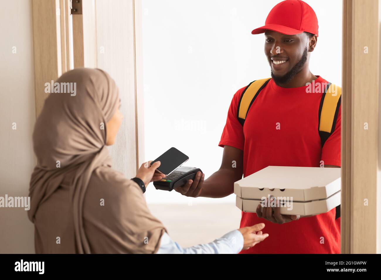 black-delivery-man-holding-pizza-box-and-pos-terminal-stock-photo-alamy