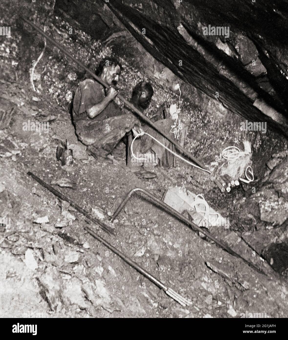 White miner with black man preparing an explosives charge in City & Suburban Gold Mine, Johannesburg, South Africa Stock Photo