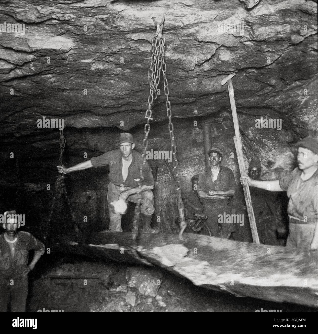 Miners with conveyor belt for ore in a stope, City & Suburban Gold Mine, Johannesburg, South Africa Stock Photo