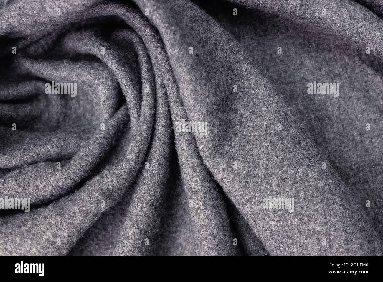 Grey woolen cozy scarf texture close-up. Stock Photo