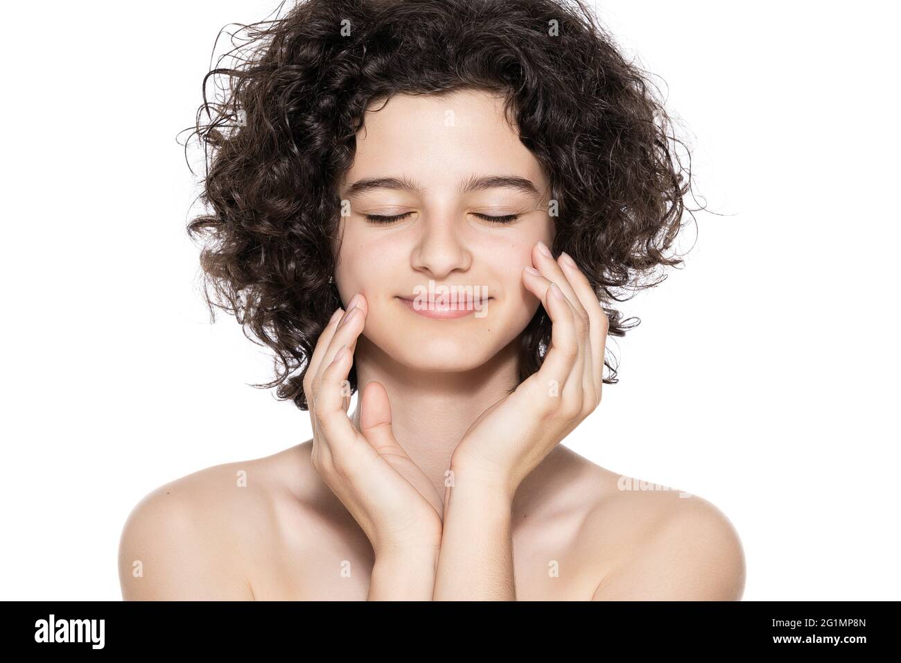 Teenager skincare. Beautiful teenage girl with gorgeous curly hair and ...
