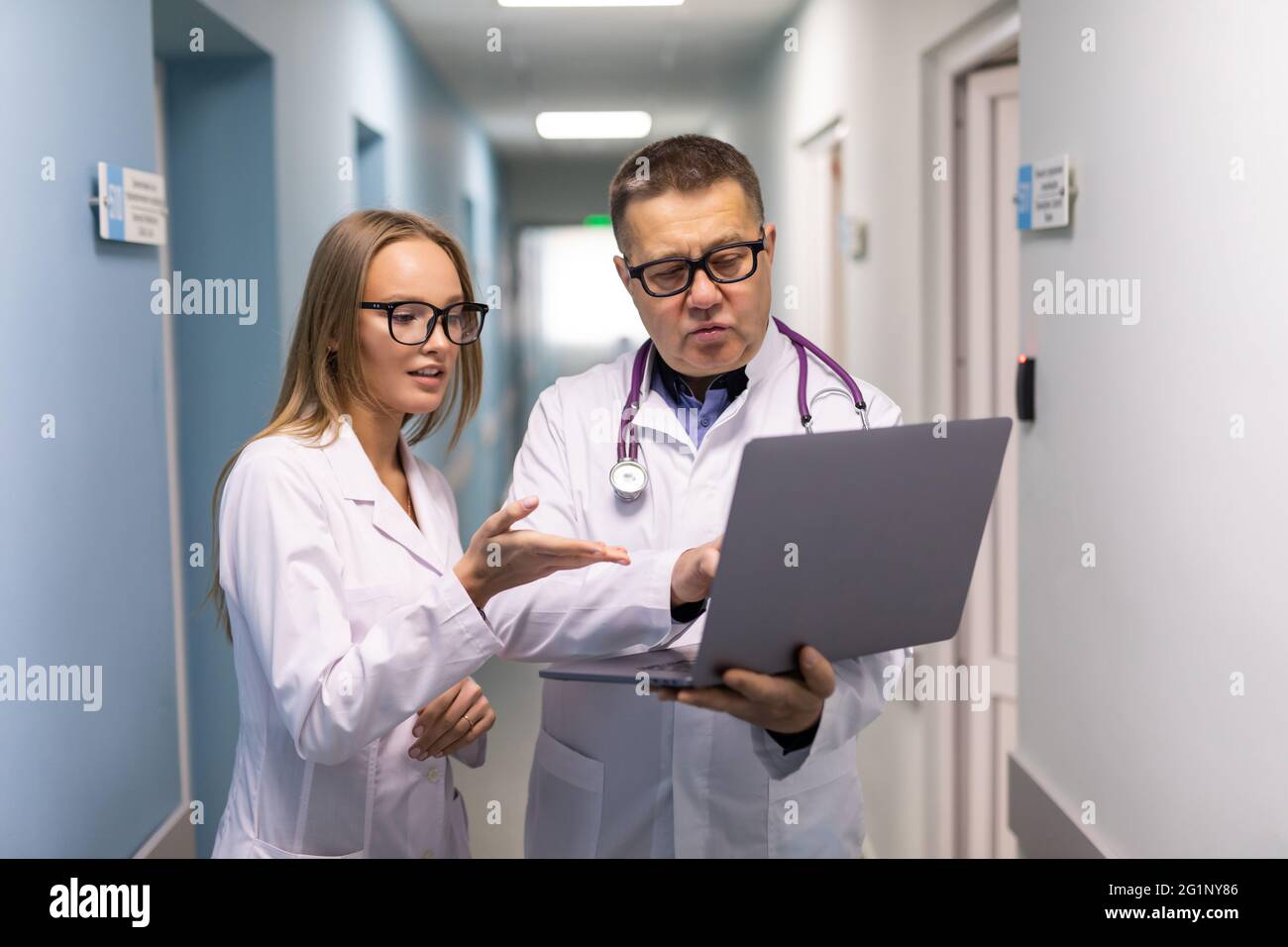 Photo of two doctors together discussing new way of treatment while ...