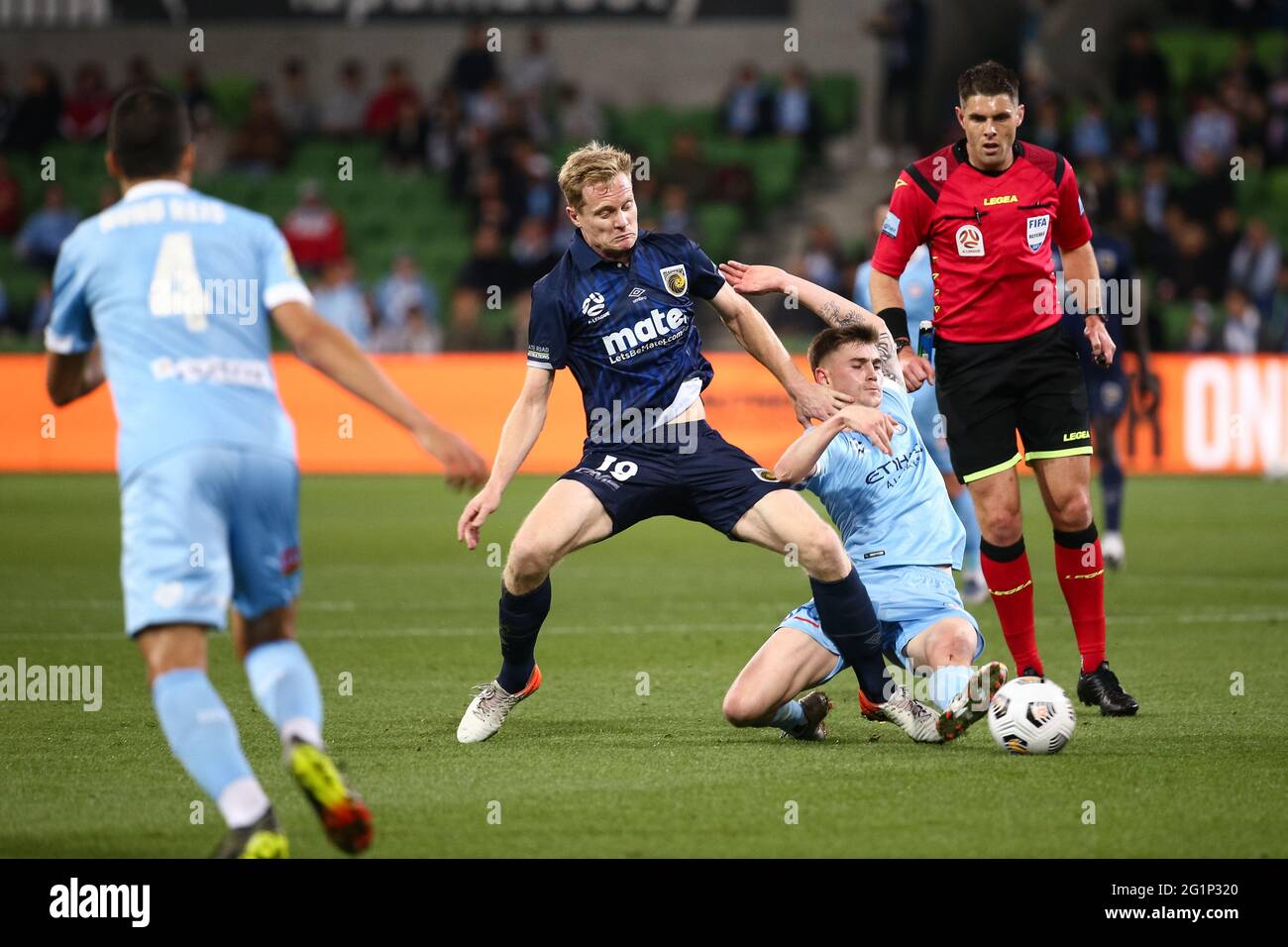 MELBOURNE, AUSTRALIA - MAY 22: Matt Simon of the Central Coast Mariners  controls the ball ahead of Connor Metcalfe of Melbourne City during the  Hyundai A-League soccer match between Melbourne City FC