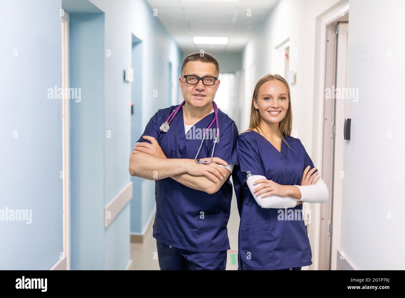 Two doctors discussing diagnosis while walking Stock Photo