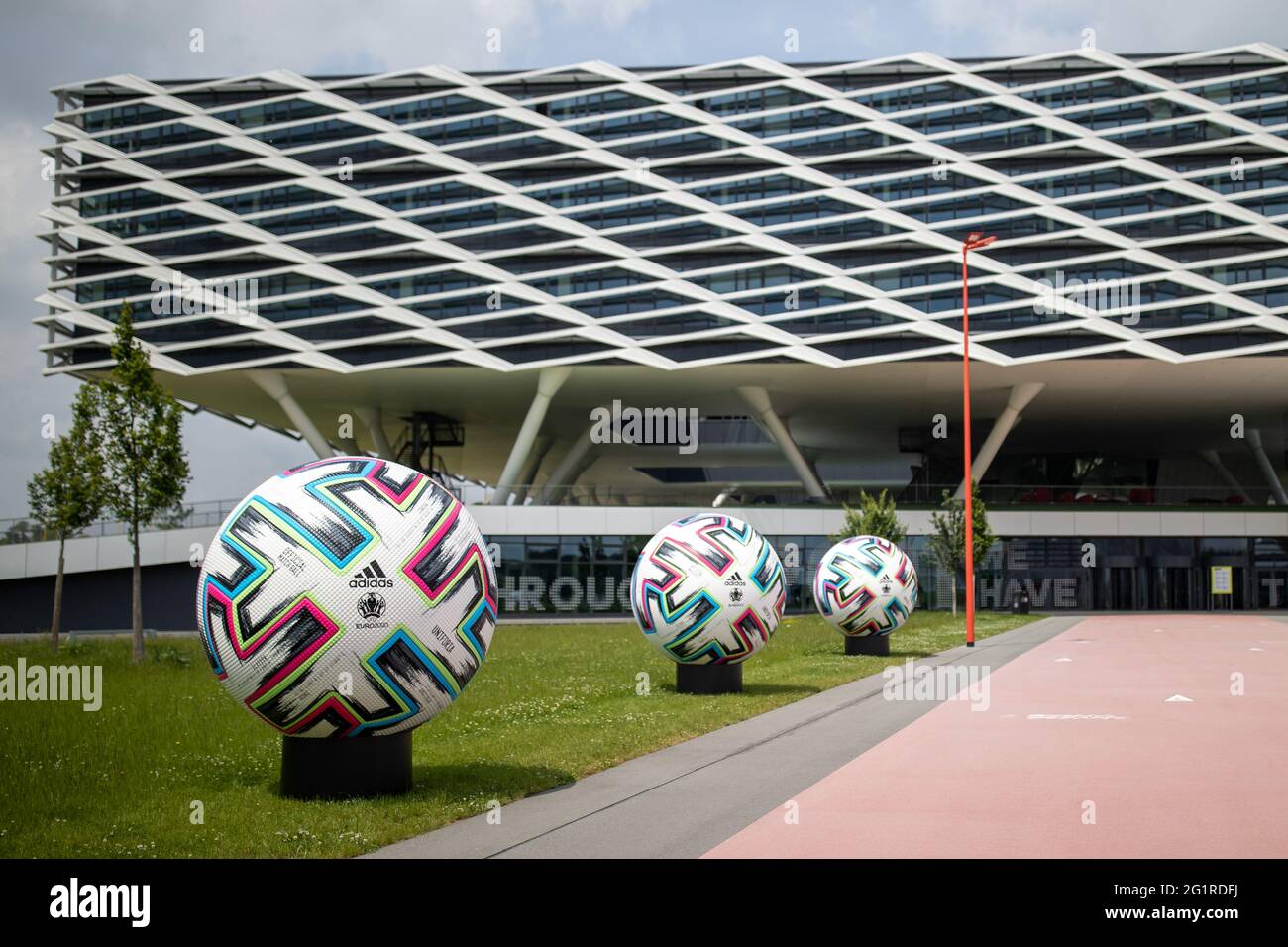 07 June 2021, Bavaria, Herzogenaurach: Oversized official match balls  "Uniforia" of EURO 2020 stand in front of the office building "Arena" on  the premises of the sporting goods manufacturer adidas. The German