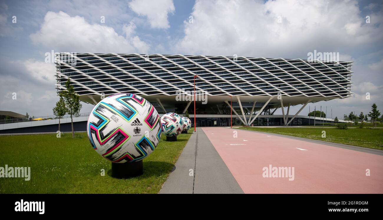 07 June 2021, Bavaria, Herzogenaurach: An oversized official match ball  "Uniforia" of EURO 2020 stands in front of the office building "Arena" on  the premises of the sporting goods manufacturer adidas. The