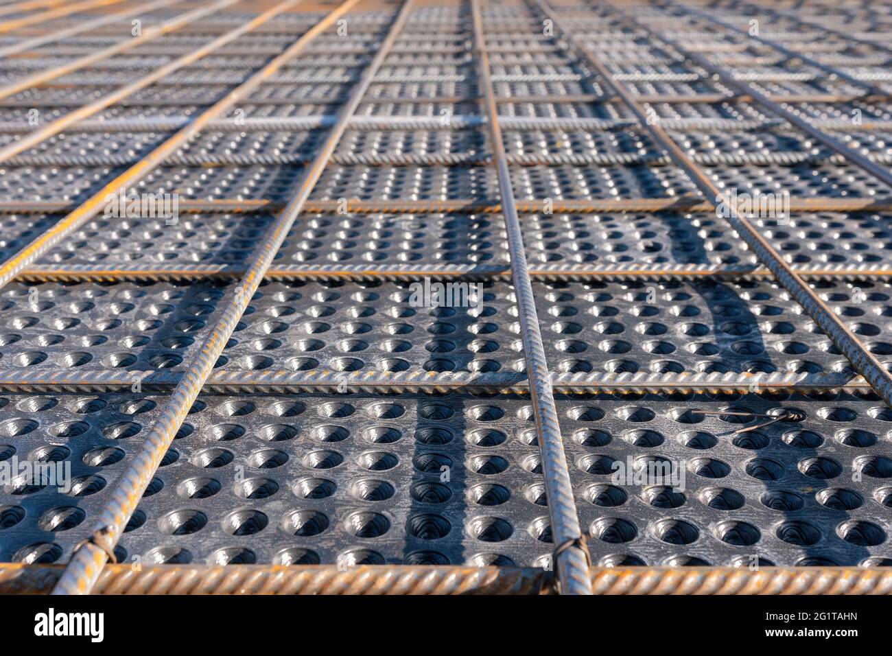 Close up view of reinforcement of concrete. Geometric alignment of Rebars on construction site. Reinforcements steel bars stack. Stock Photo