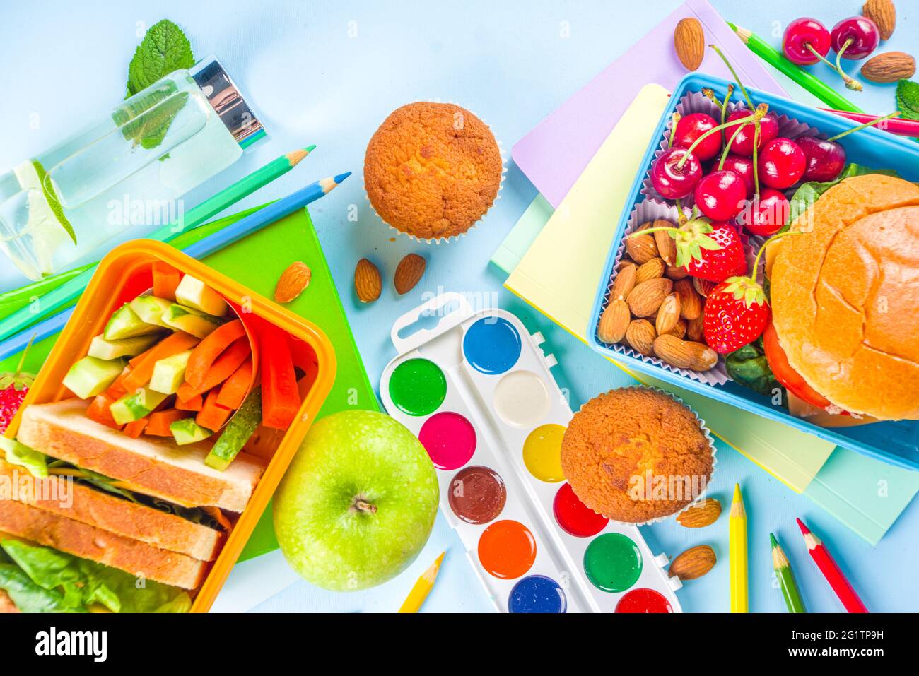 https://c8.alamy.com/comp/2G1TP9H/back-to-school-healthy-tasty-kid-lunch-box-with-sandwiches-nuts-fresh-fruits-and-vegetable-sticks-with-school-supplies-pencils-notebooks-on-bri-2G1TP9H.jpg