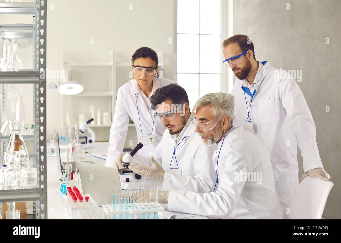 Diverse scientist group brainstorming discussing research report at laboratory Stock Photo