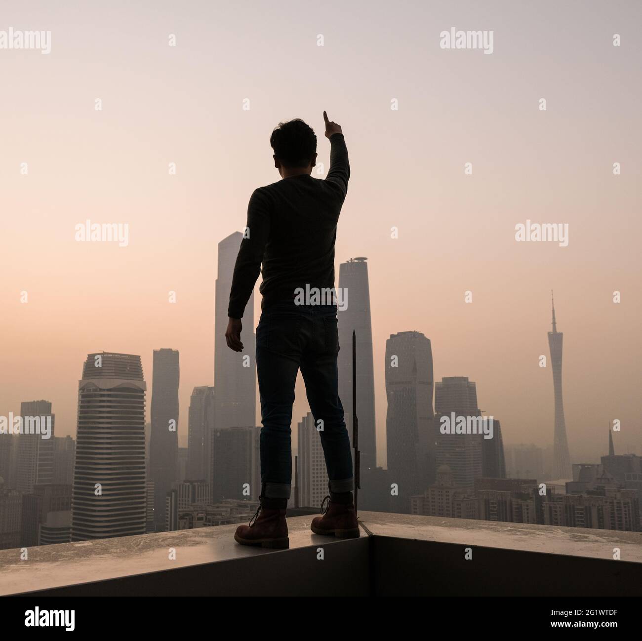 Young man with backpack looking at Beijing skyline Stock Photo
