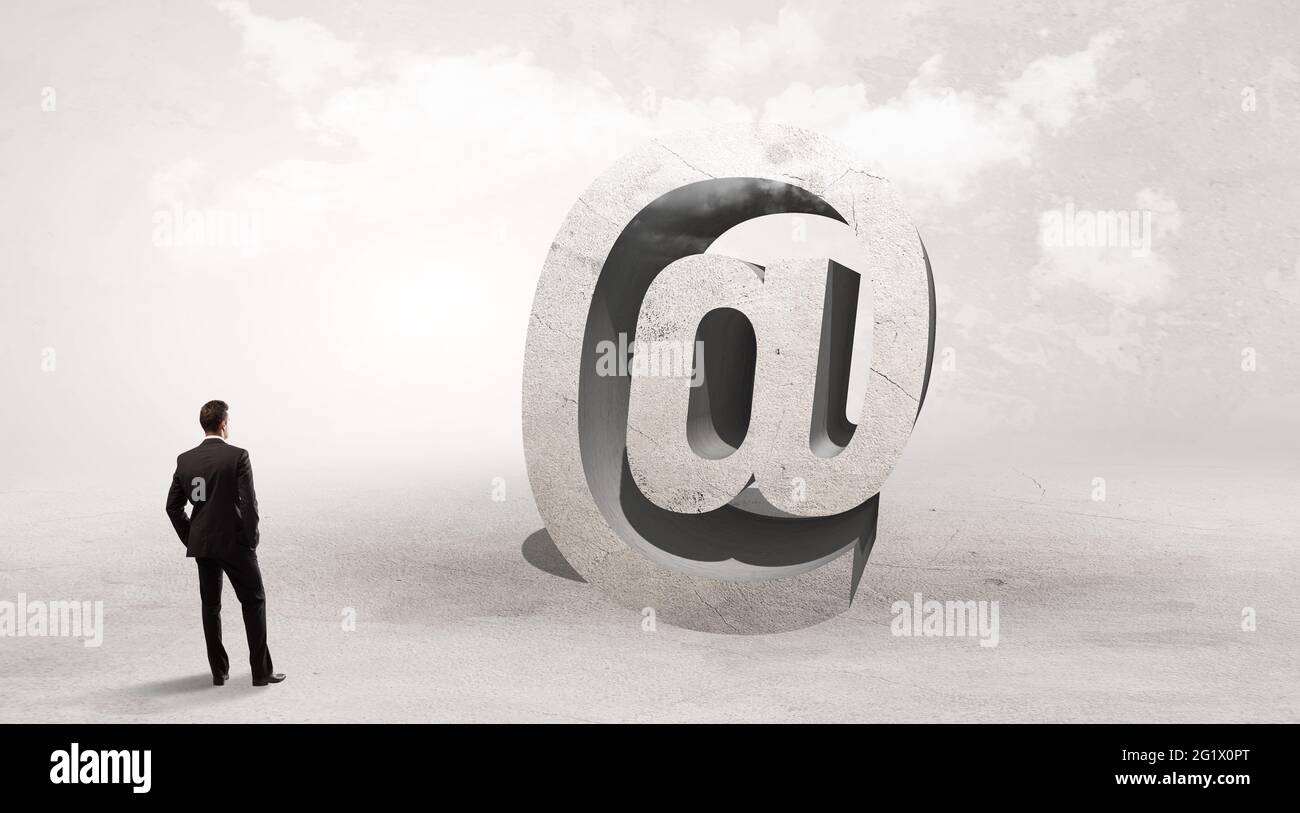 Rear view of a businessman standing in front of abbreviation concept Stock Photo Alamy