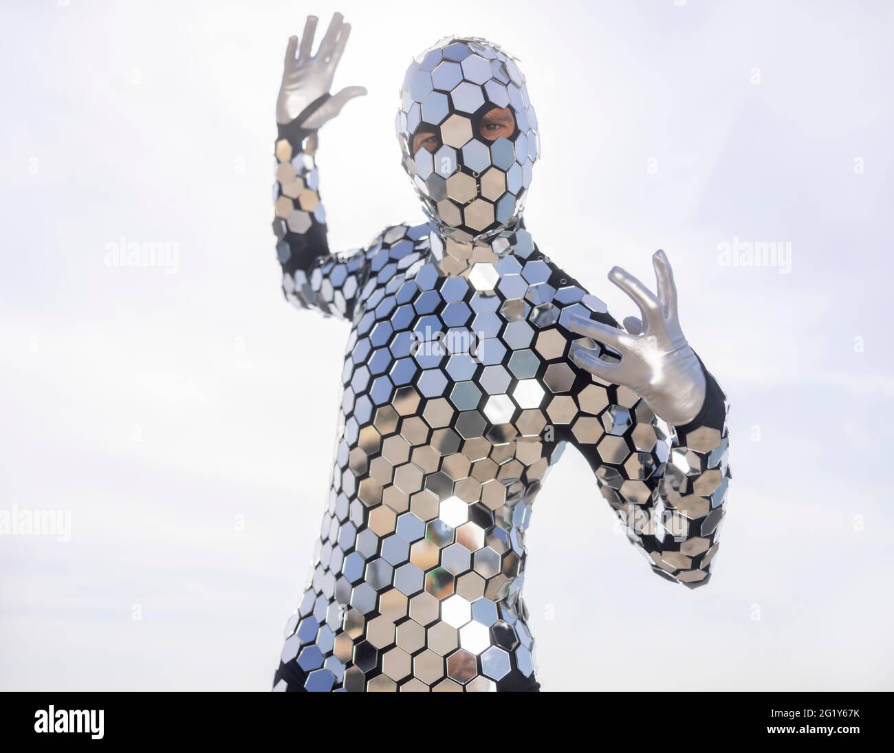 Sparkling discosuit man dancing next to the sea Stock Photo