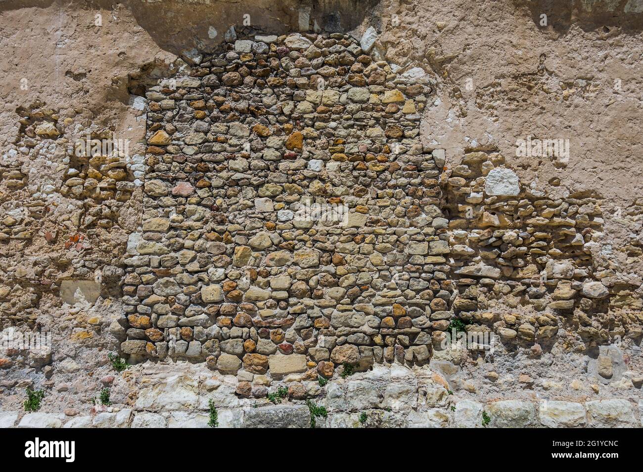 Old random stone side wall of abbey church of Saint Pierre, Beaulieu-lès-Loches, Indre-et-Loire (37), France. Stock Photo