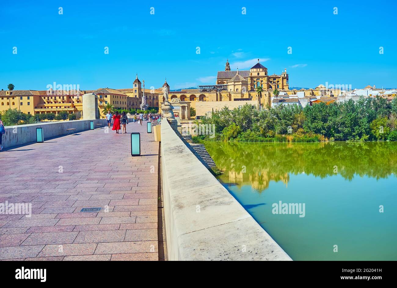 Walk the ancient stone Roman Bridge (Puente Romano), watch the riverside city views and medieval Mosque-Cathedral (Mezquita), Cordoba, Spain Stock Photo