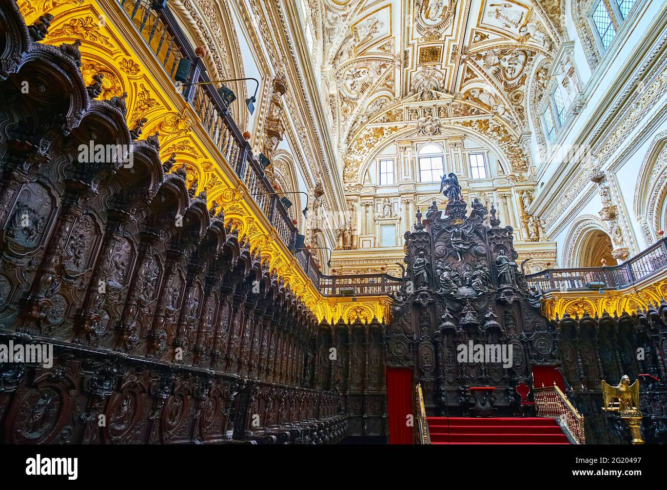 CORDOBA, SPAIN - SEP 30, 2019: The outstanding mahogany wooden choir stalls  in Capilla Mayor (Main Chapel) of Mezquita- Catedral, on Sep 30 in Cordob Stock Photo