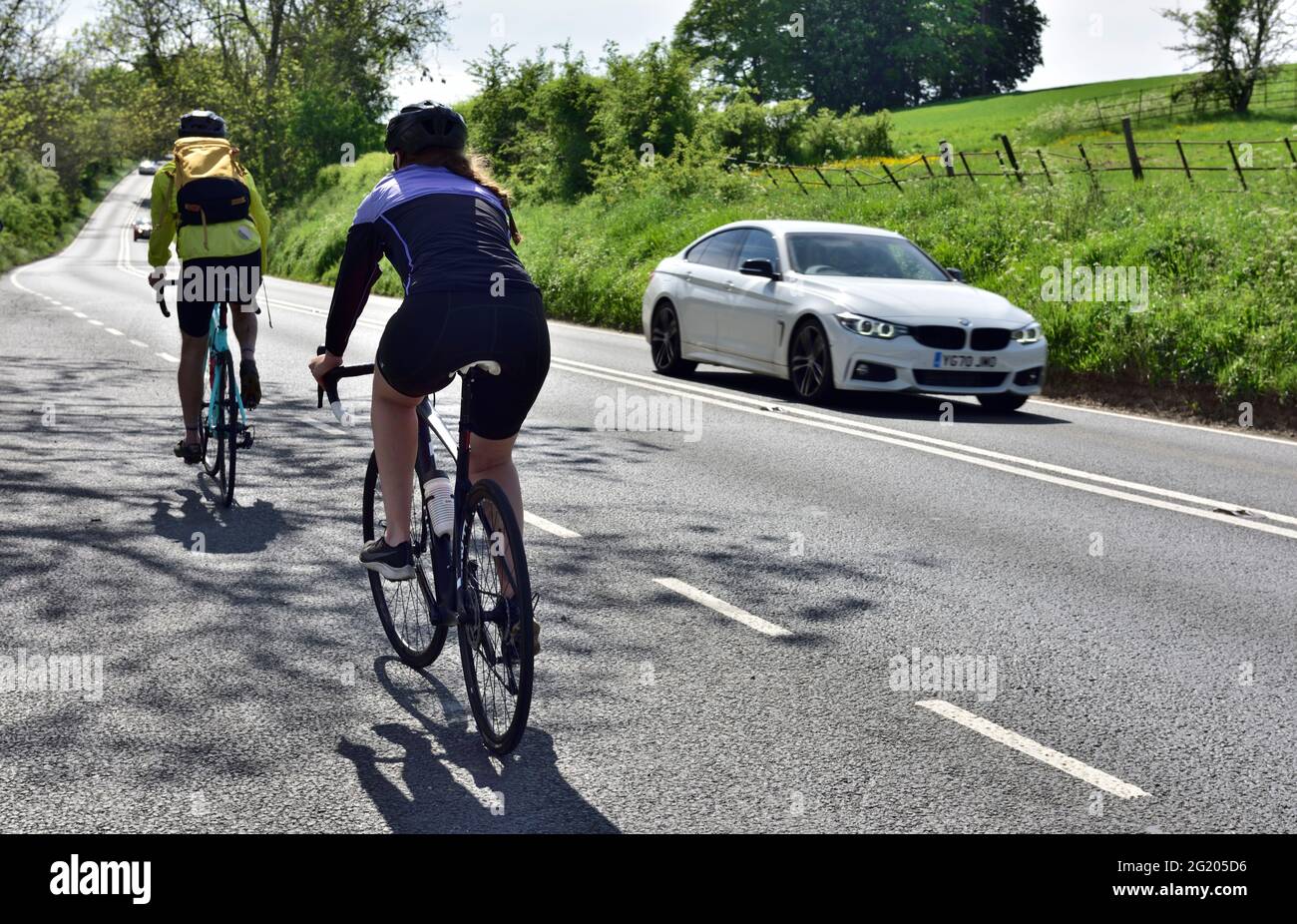 Two cyclists touring the British countryside on Cotswold Way, Gloucestershire Stock Photo