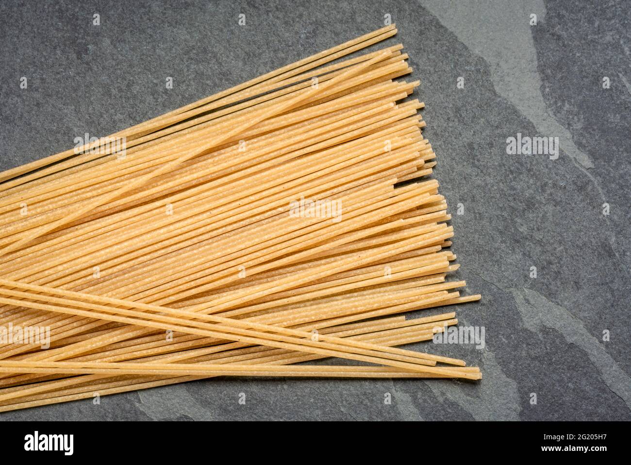 gluten and grain free Italian spaghetti pasta sourced from casava flour, top view on a slate stone board Stock Photo