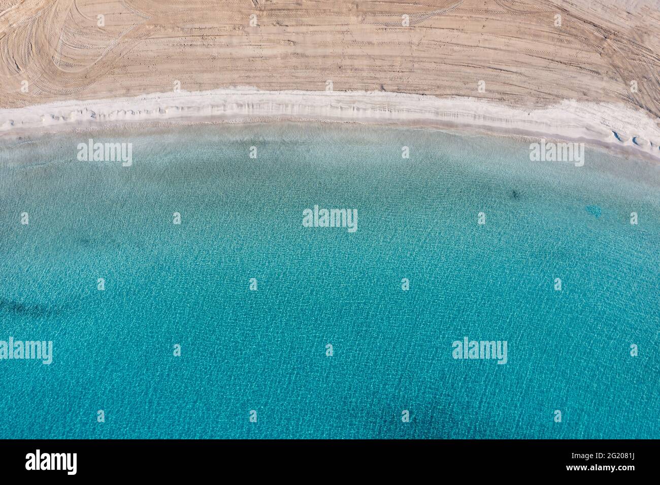 Sandy beach, turquoise blue color sea aerial drone top down view. Clear water, Platia ammos beach cleaned and empty, Koufonisi, Small Cyclades. Aegean Stock Photo