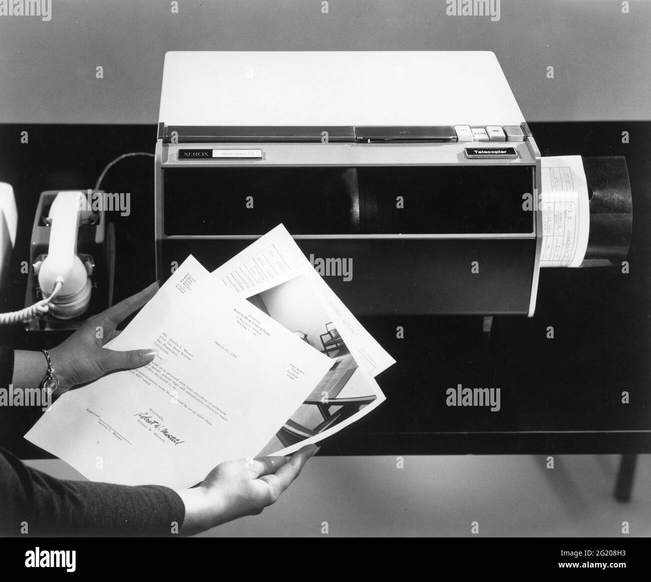 A new office machine - the Xerox Magnafax Telecopier - can look at a picture or letter and convert the image to sound over a telephone. At the other end on the receiving telephone, a similar machine reconverts the sound to a picture a few minutes later, Rochester, NY, 1966. (Xerox/RBM Vintage Images) Stock Photo