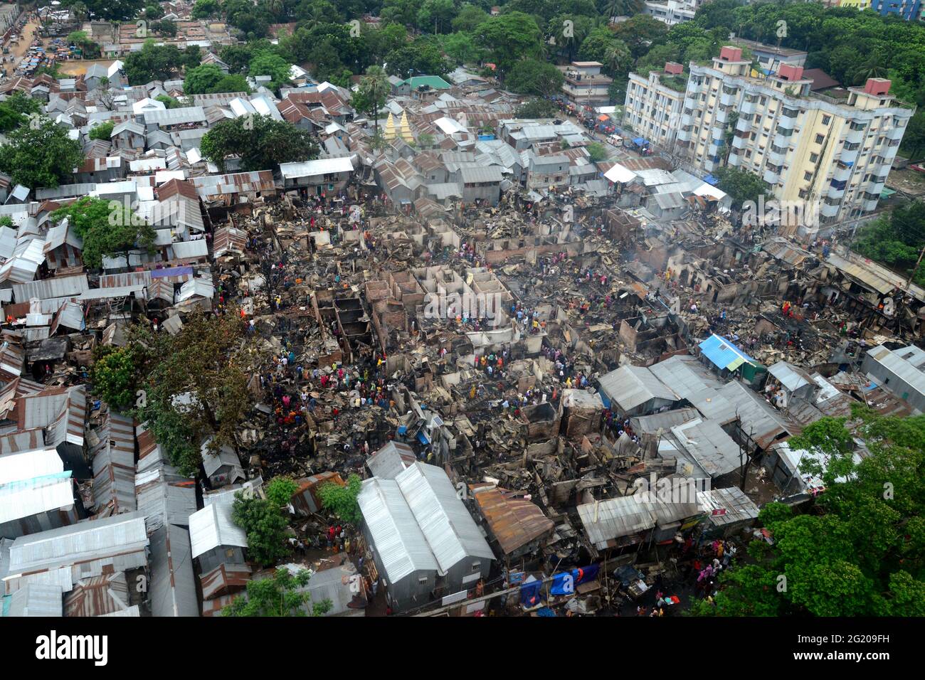 A top view of Mohakhali slum after a devastating fire that broke out in Dhaka, Bangladesh, on June 7, 2021. At least 300 shanties were gutted as the devastating fire that broke out at Mohakhali slum in Dhaka. Stock Photo