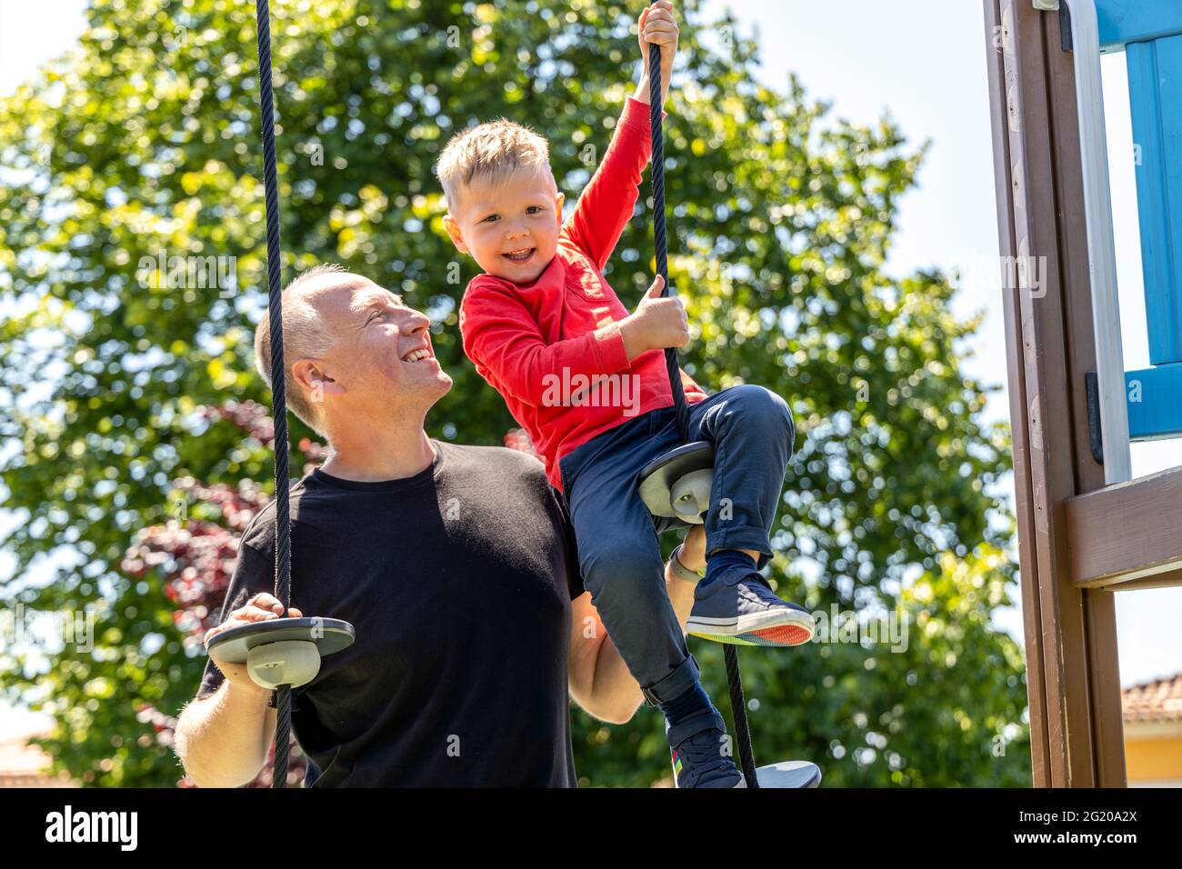 Father playing with his 3 years old son on the playground Stock Photo