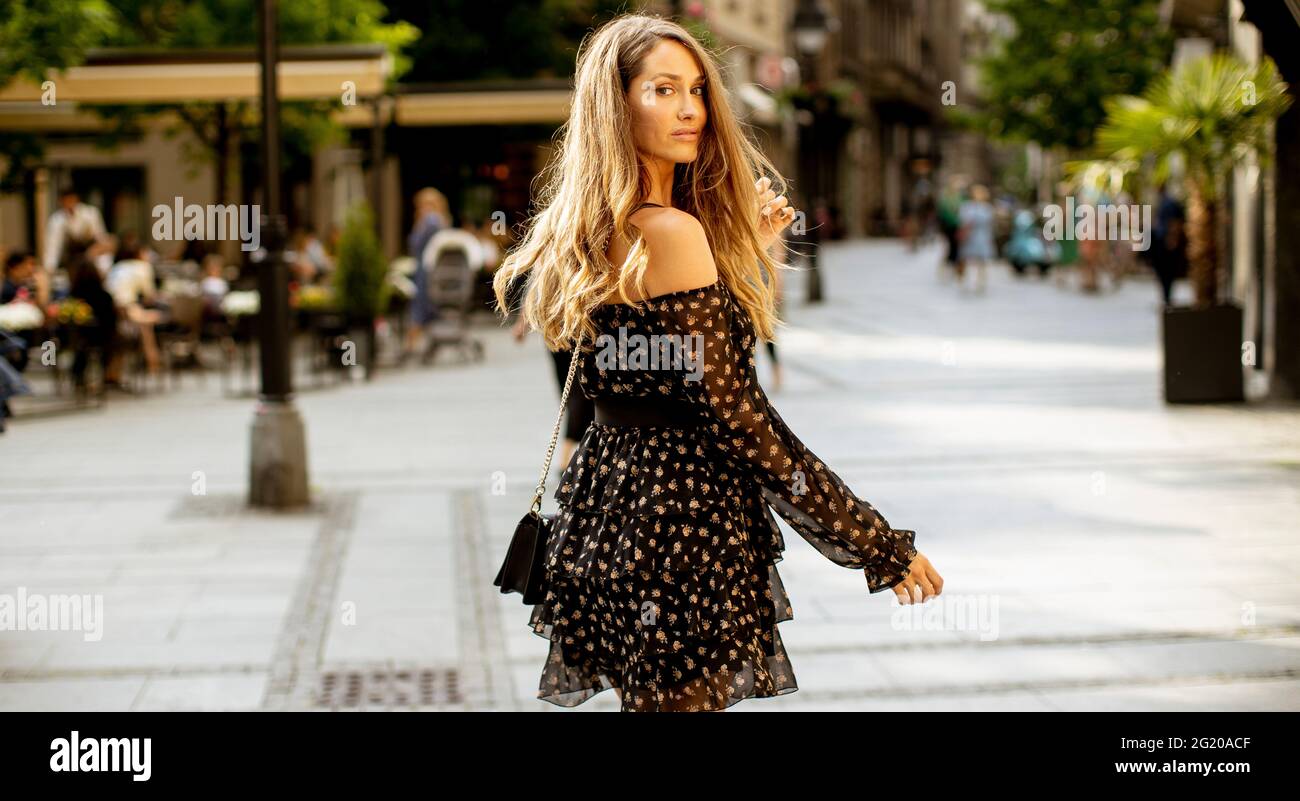 Pretty young long hair brunette woman walking on the city street Stock ...