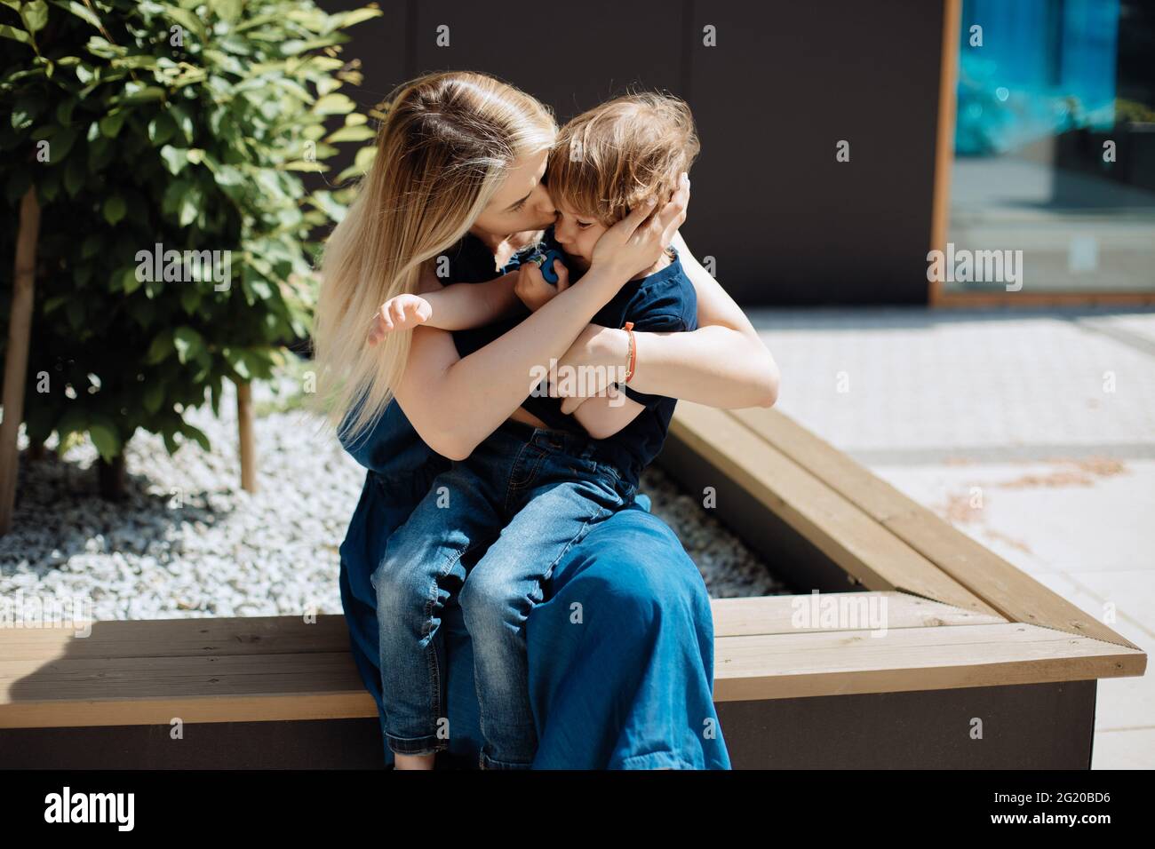 Mom soothes and hugs her 3-year-old son. Child education concept Stock Photo