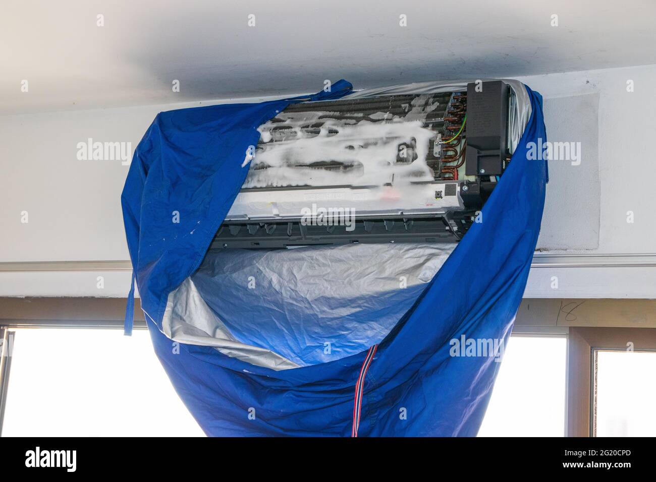 Maintenance cleaning an air conditioner Stock Photo